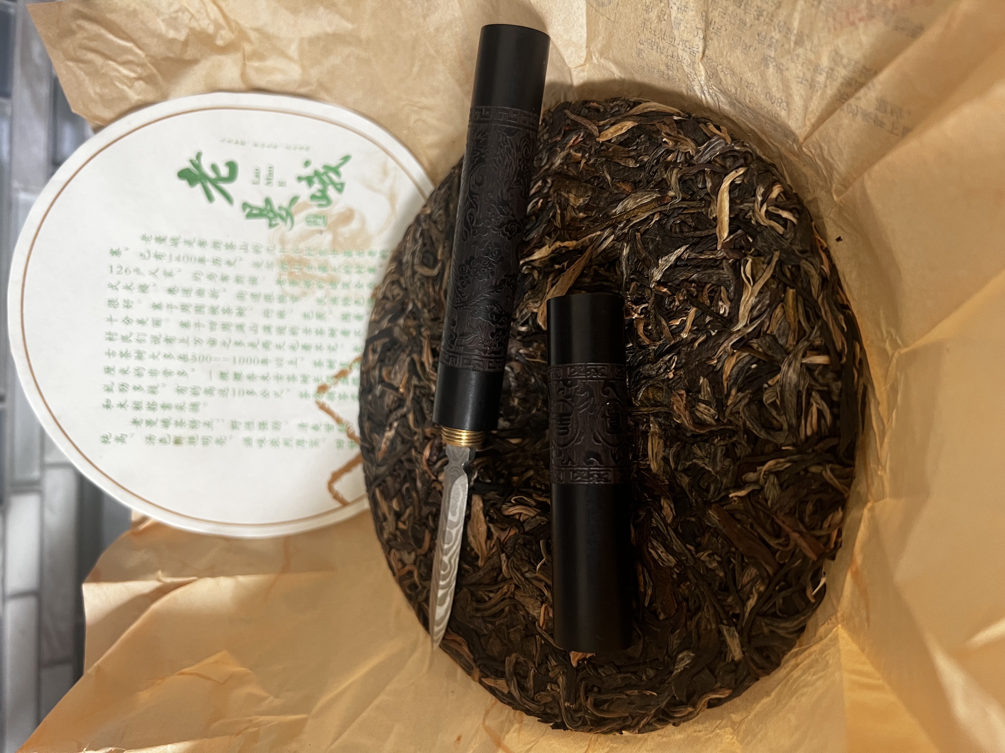 The tea cake resting on its wrapping, with the label behind it.